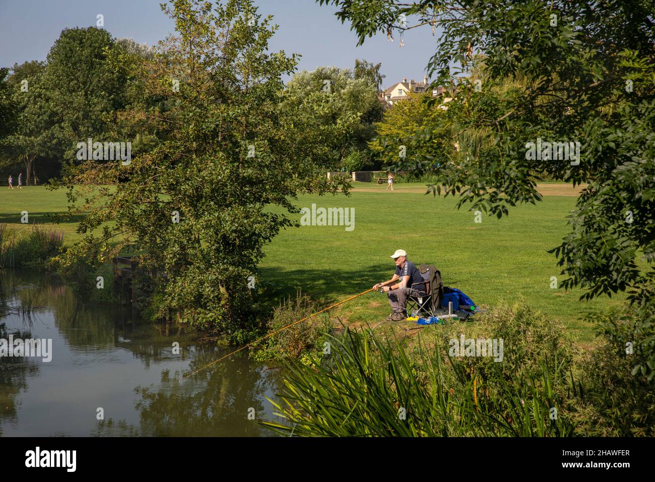 UK, England, Lincolnshire Stamford, Town Meadow, man fishing on River Welland Stock Photo