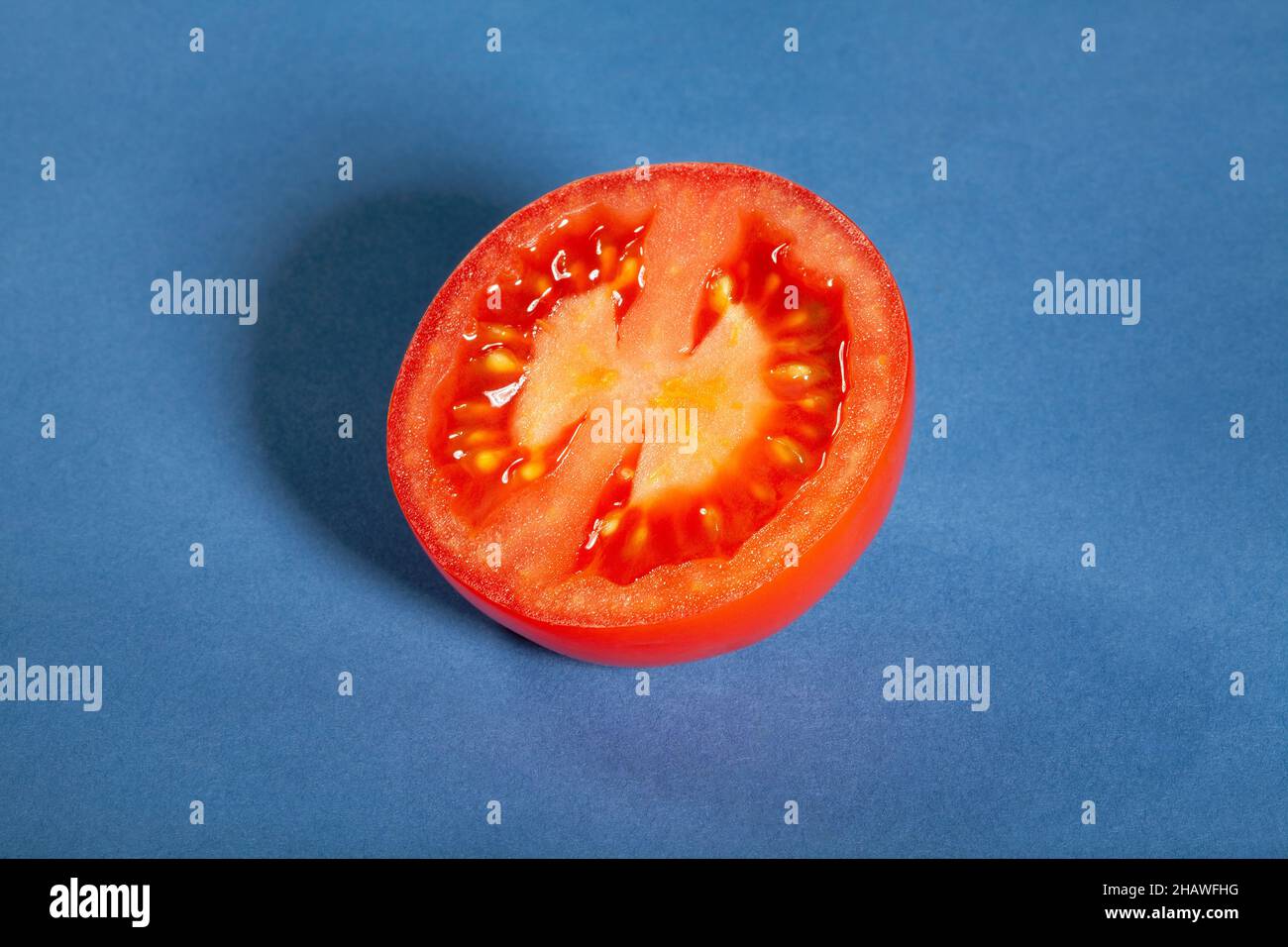 plum tomato on blue background Stock Photo