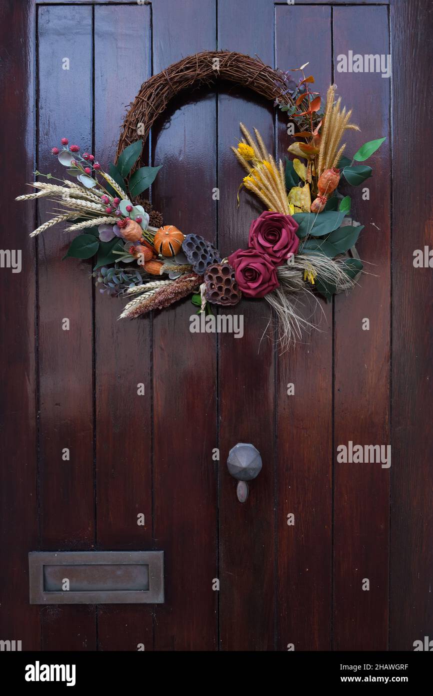 Autumn wreath/garland on outside wooden door in Scotland, UK Stock Photo