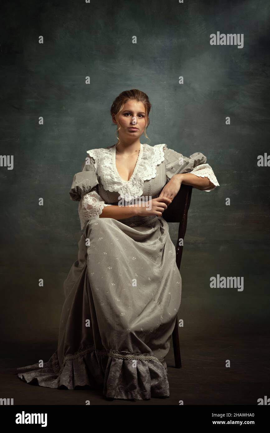 Vintage portrait of young beautiful girl in gray dress of medieval ...