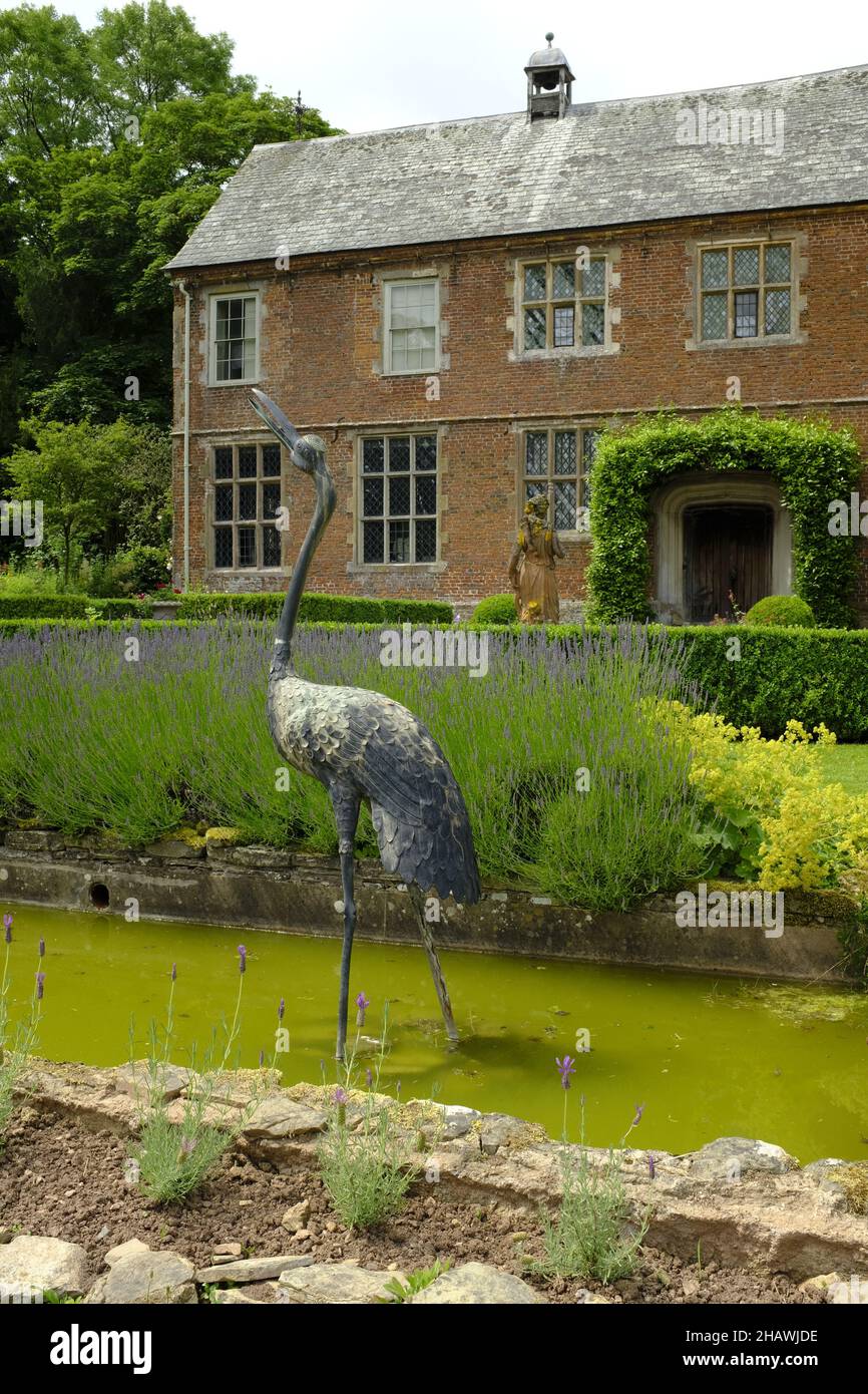 Sculpture of a bird in the gardens in front of historic Hellens House, Much Marke, Herts, UK Stock Photo