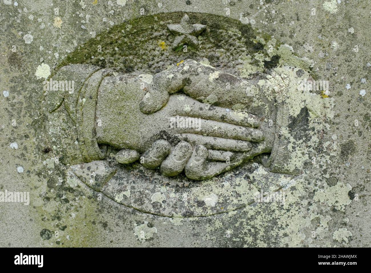 Shaking hands (male and female) carved into the stone on a 19th-century gravestone, St. Issui's Church, Partrishow, Powys, Wales Stock Photo