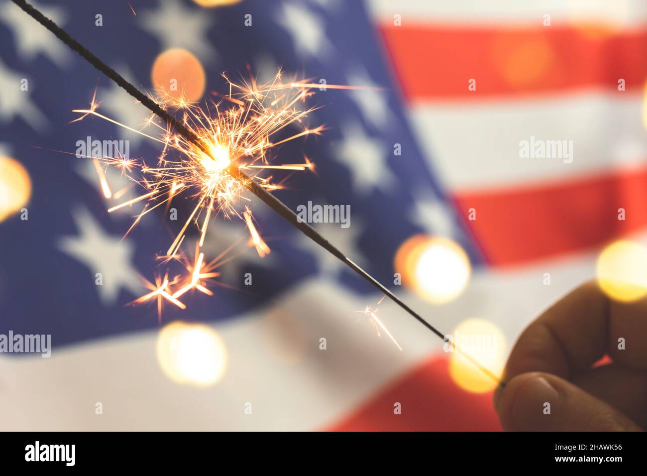 American flag and sparklers in hand. USA, 4th of July celebration ...