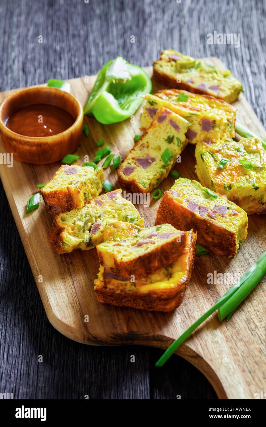 Baked Denver Omelette pieces on a cutting board, american recipe,  horizontal view from above Stock Photo