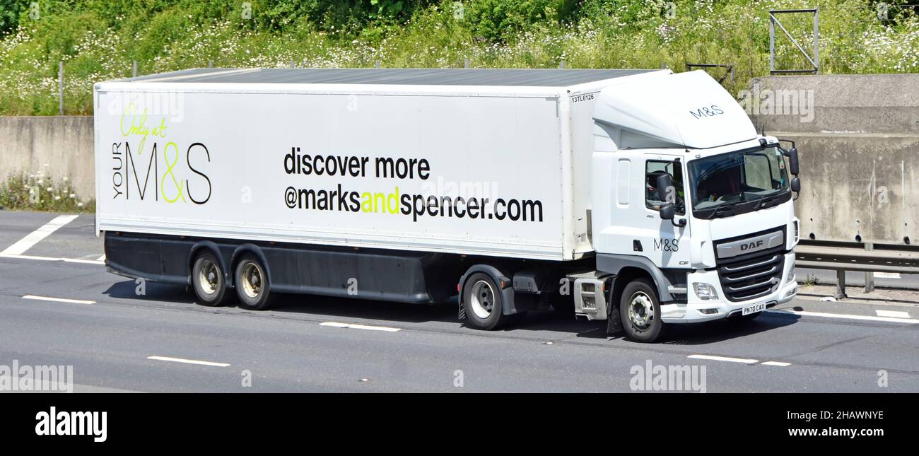 Marks and Spencer retail business side front view white DAF supply chain lorry truck driver advertising on trailer discover your M&S on UK motorway Stock Photo
