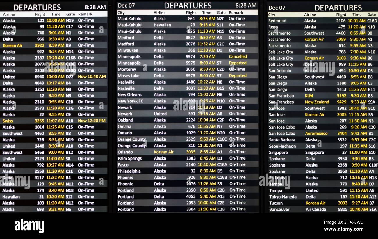 SeaTac, WA, USA - December 07, 2021; Digital departure board at Seattle Tacoma International Airport.  The flights from SeaTac are mostly on time Stock Photo