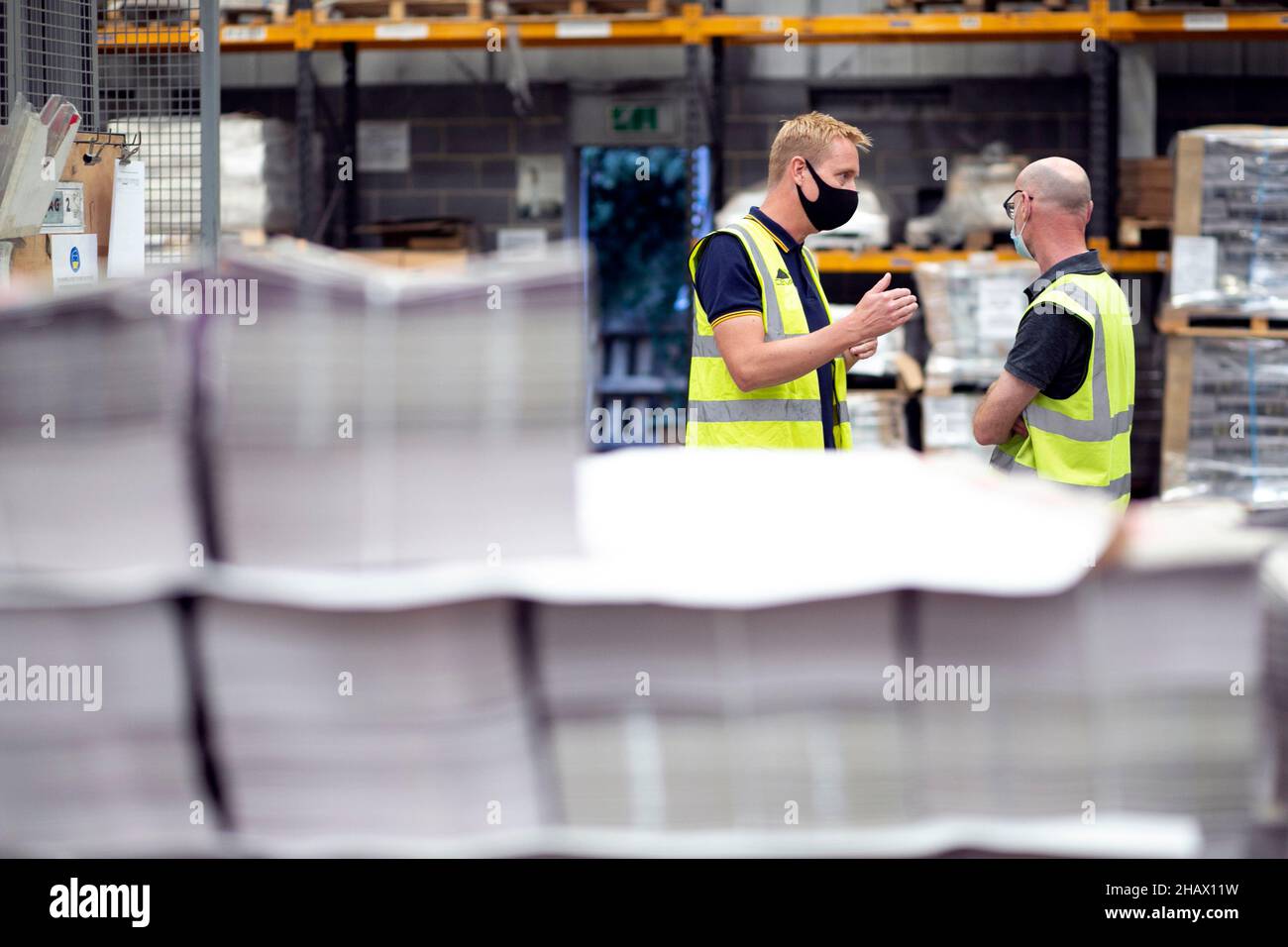 Roger Clapham ( Guardian head of supply) talks with Matt Stretton ( Guardian account manager at YM Chantry) during the binding process of the new Guar Stock Photo
