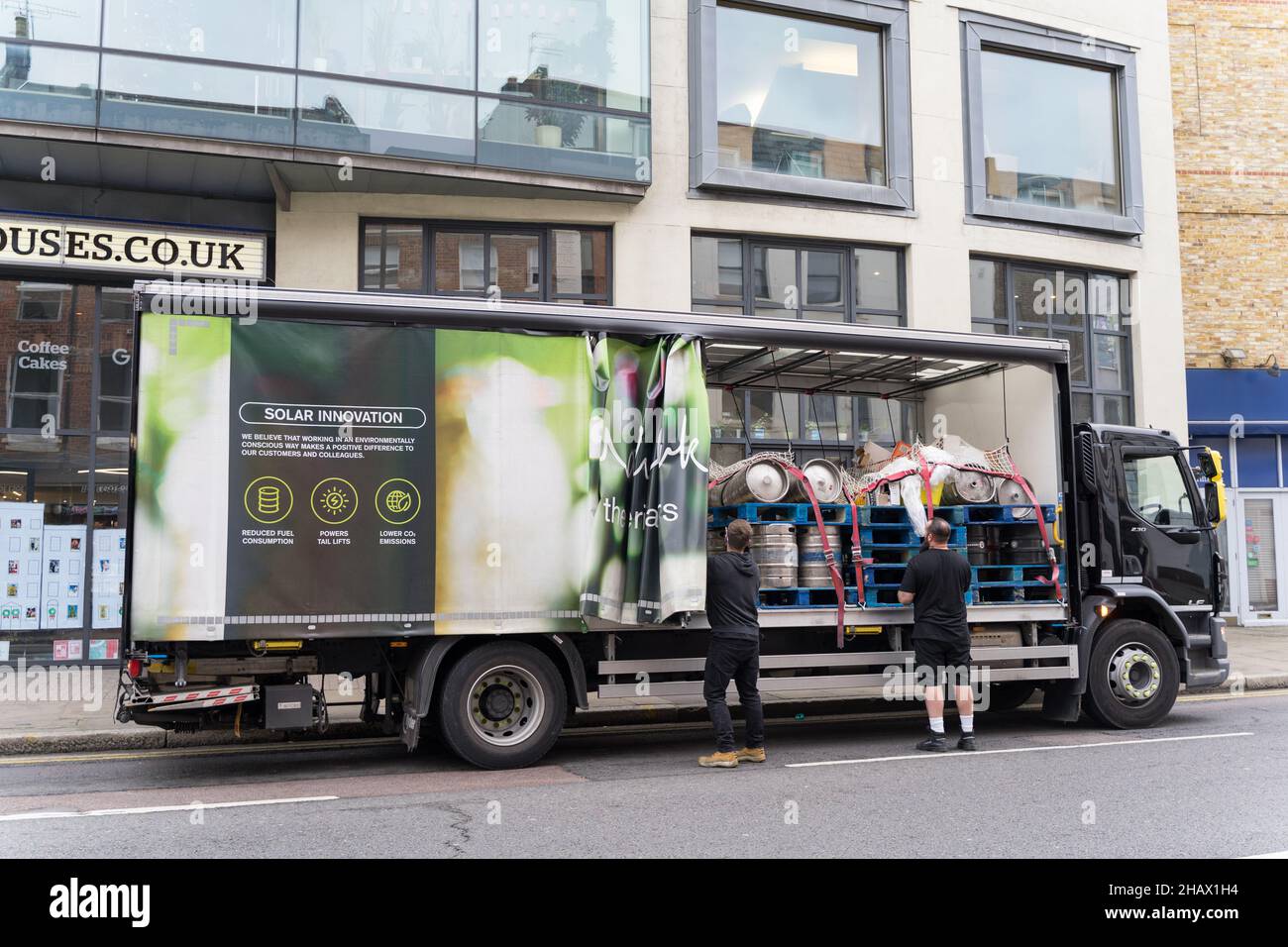 two delivery men unload the beer barrels off from Matthew Clark delivery  truck London Greenwich England UK Stock Photo - Alamy