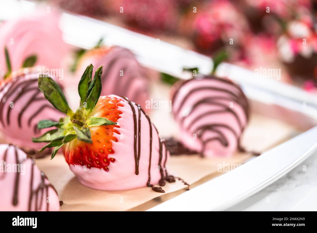 Variety of chocolate dipped strawberries on parchment paper Stock Photo