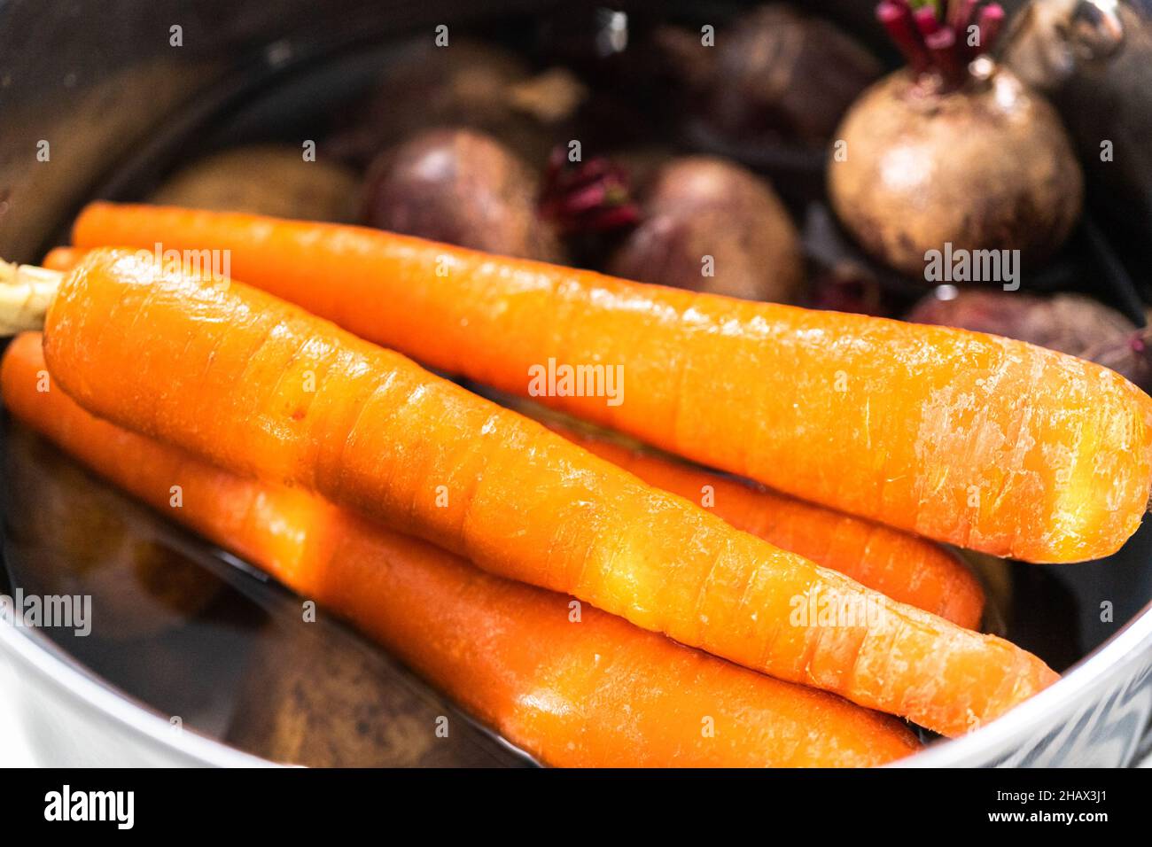 Boiling vegetables in a big cooking pot to make a vinaigrette salad