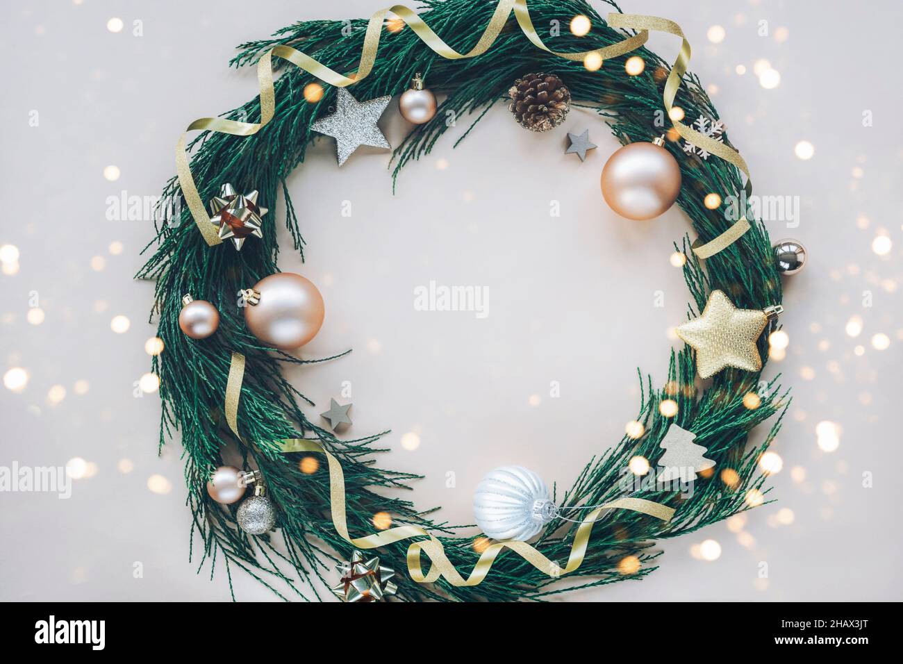 Christmas wreath made of fir tree branches on light beige background ...