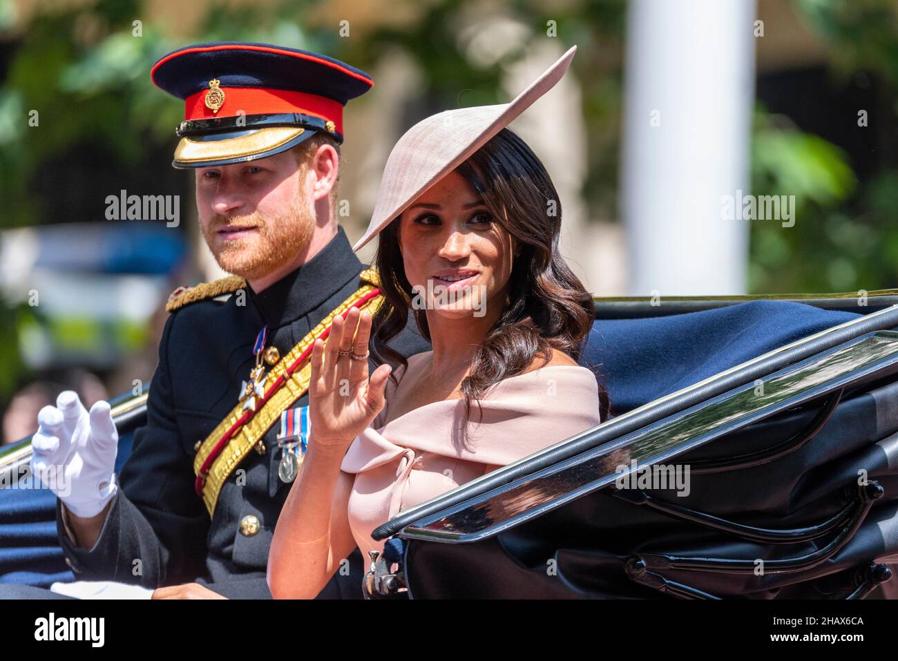 Meghan Markle, Duchess of Sussex, and Prince Harry, Duke of Sussex in carriage on The Mall, London, for Trooping the Colour 2018. Waving Stock Photo