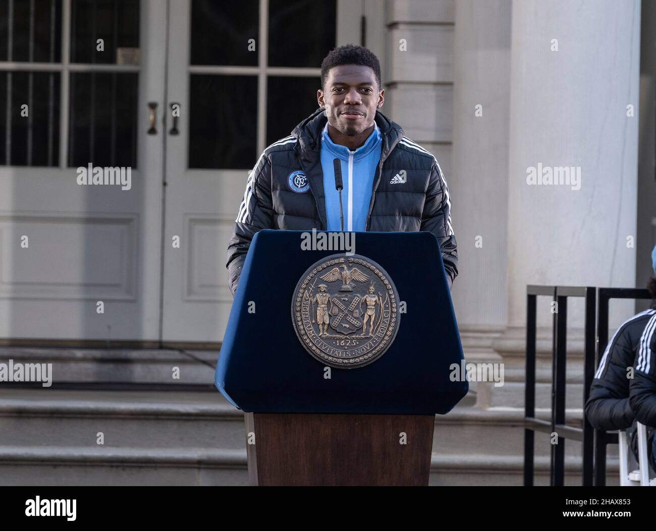 New York, New York, USA. 14th Dec, 2021. Goalkeeper Sean Johnson speaks during celebration for NYCFC winning the 2021 MLS Cup on City Hall steps. NYCFC finished the regular season in 4th place and played almost all playoff games away. Winning the MLS Cup is the first trophy won by the franchise since it was established 7 years ago. NYCFC is part of the City Football Group which owns football clubs around the world. Sean Johnson was named MVP of the playofffs. (Credit Image: © Lev Radin/Pacific Press via ZUMA Press Wire) Stock Photo