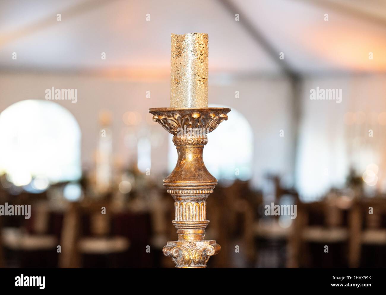 Gold candle holder centerpiece with gold candle Stock Photo Alamy