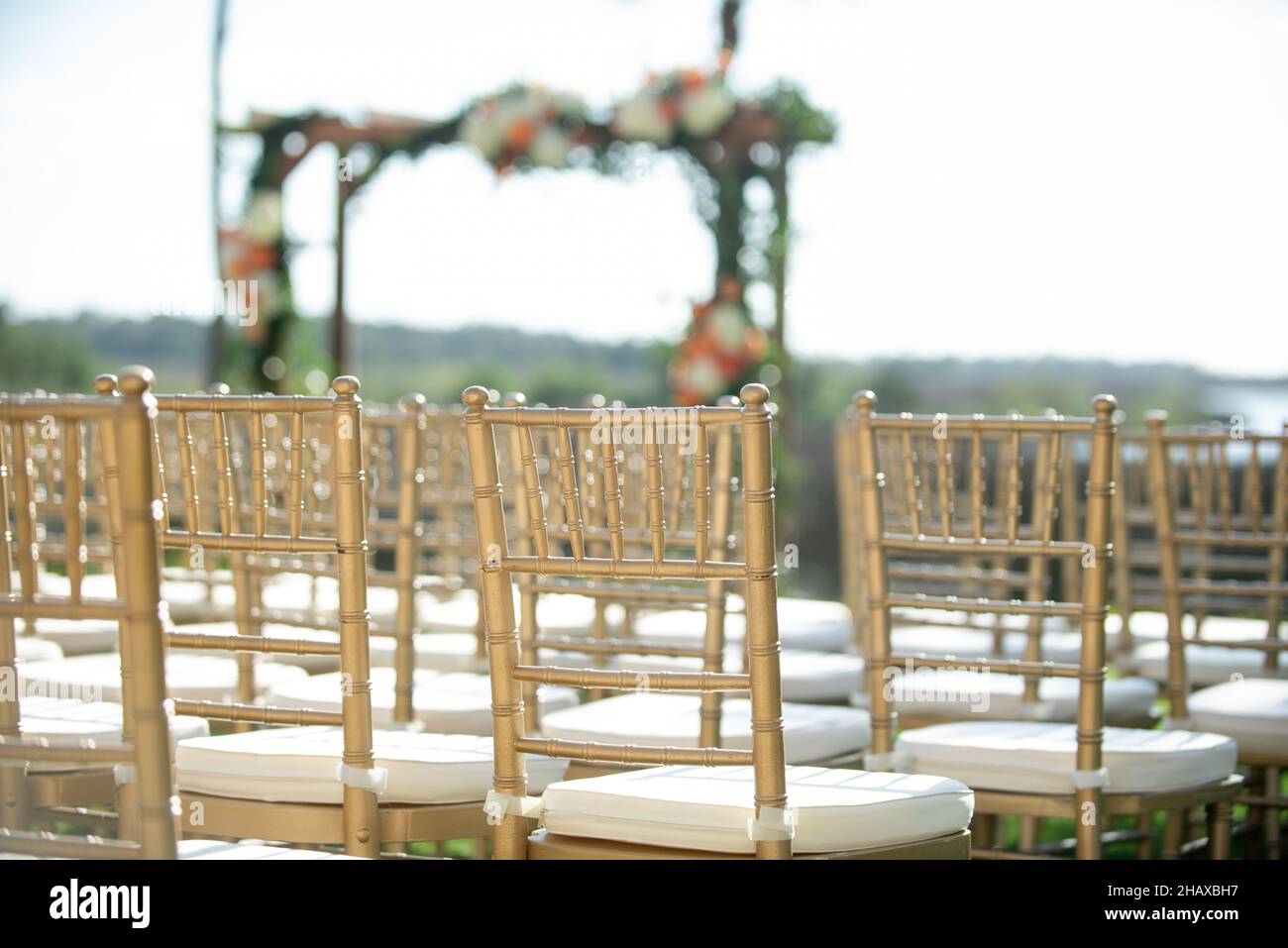 Gold chiavari chairs at outdoor wedding ceremony Stock Photo Alamy
