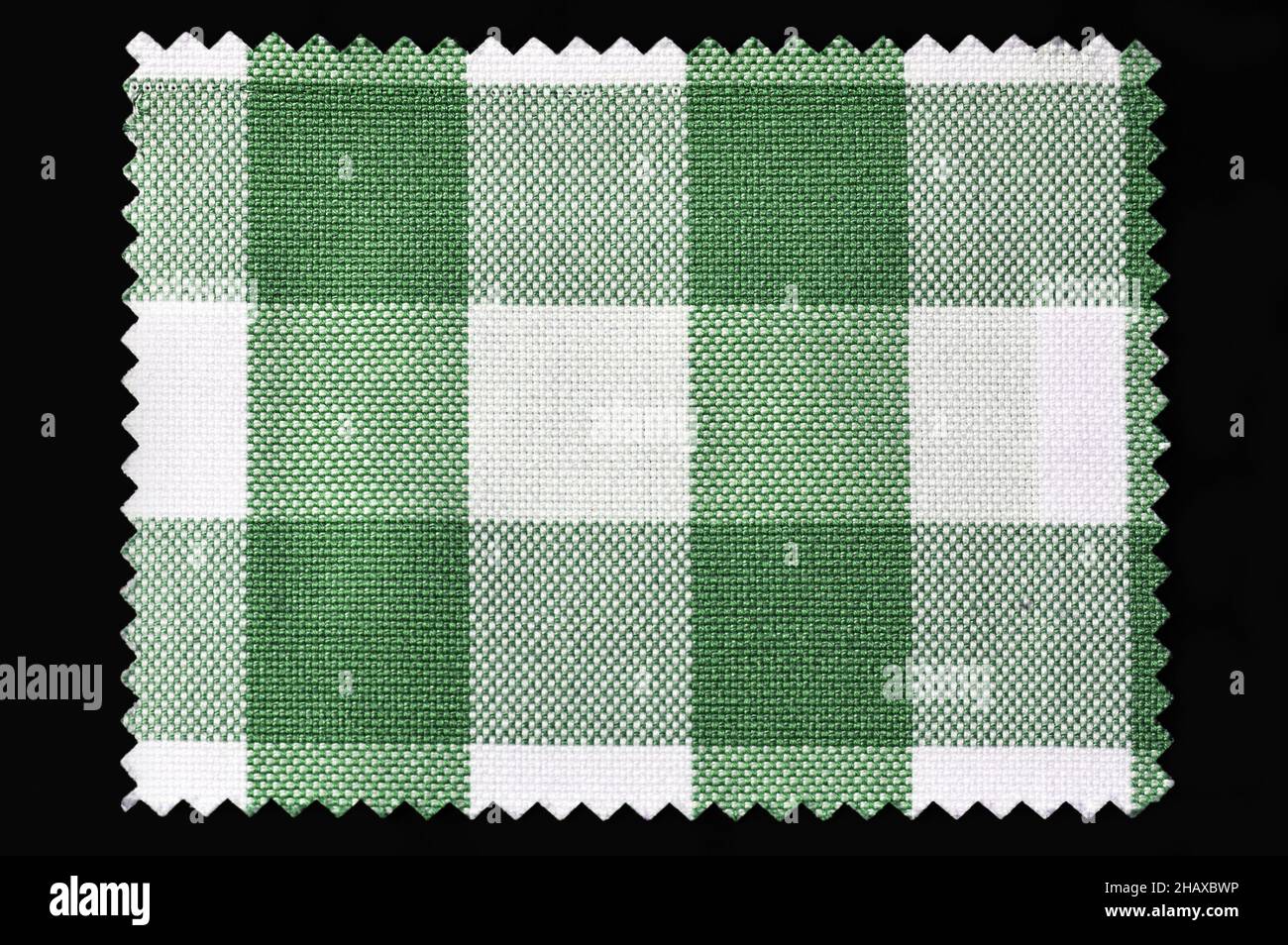 Green and white checkered fabric sample isolated on black background Stock Photo