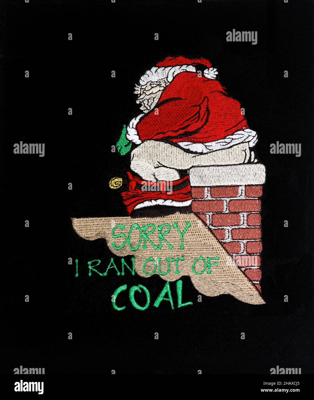Christmas decoration, Santa, sitting on chimney, roof, pants down, using chimney as toilet, words 'Sorry I ran out of coal', humorous, black backgroun Stock Photo