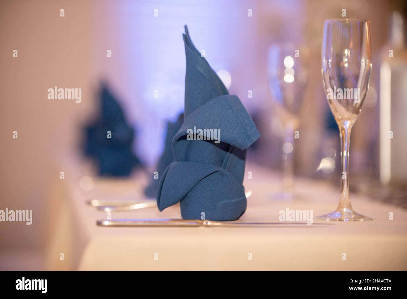 Decorative folded blue napkin on table setting Stock Photo
