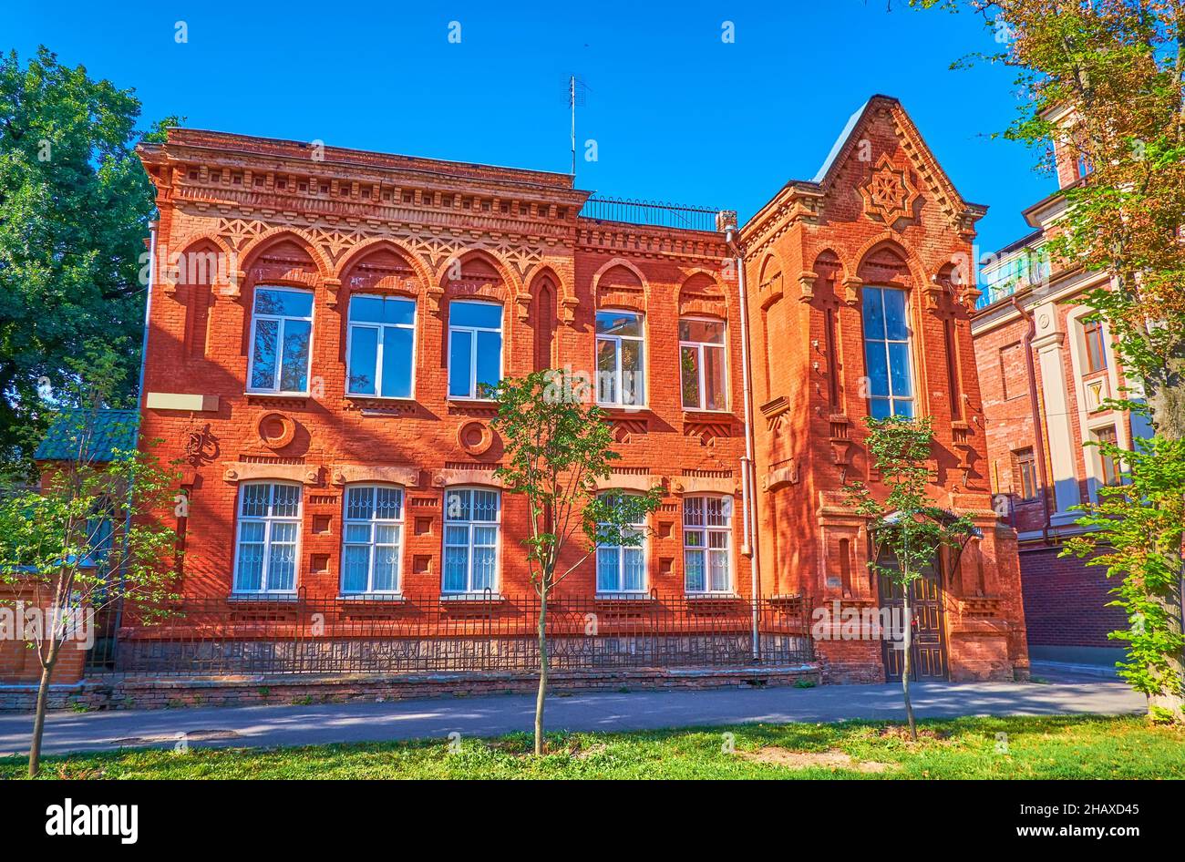 The scenic historical red brick building with decorated facade, located on Sobornosti Street in