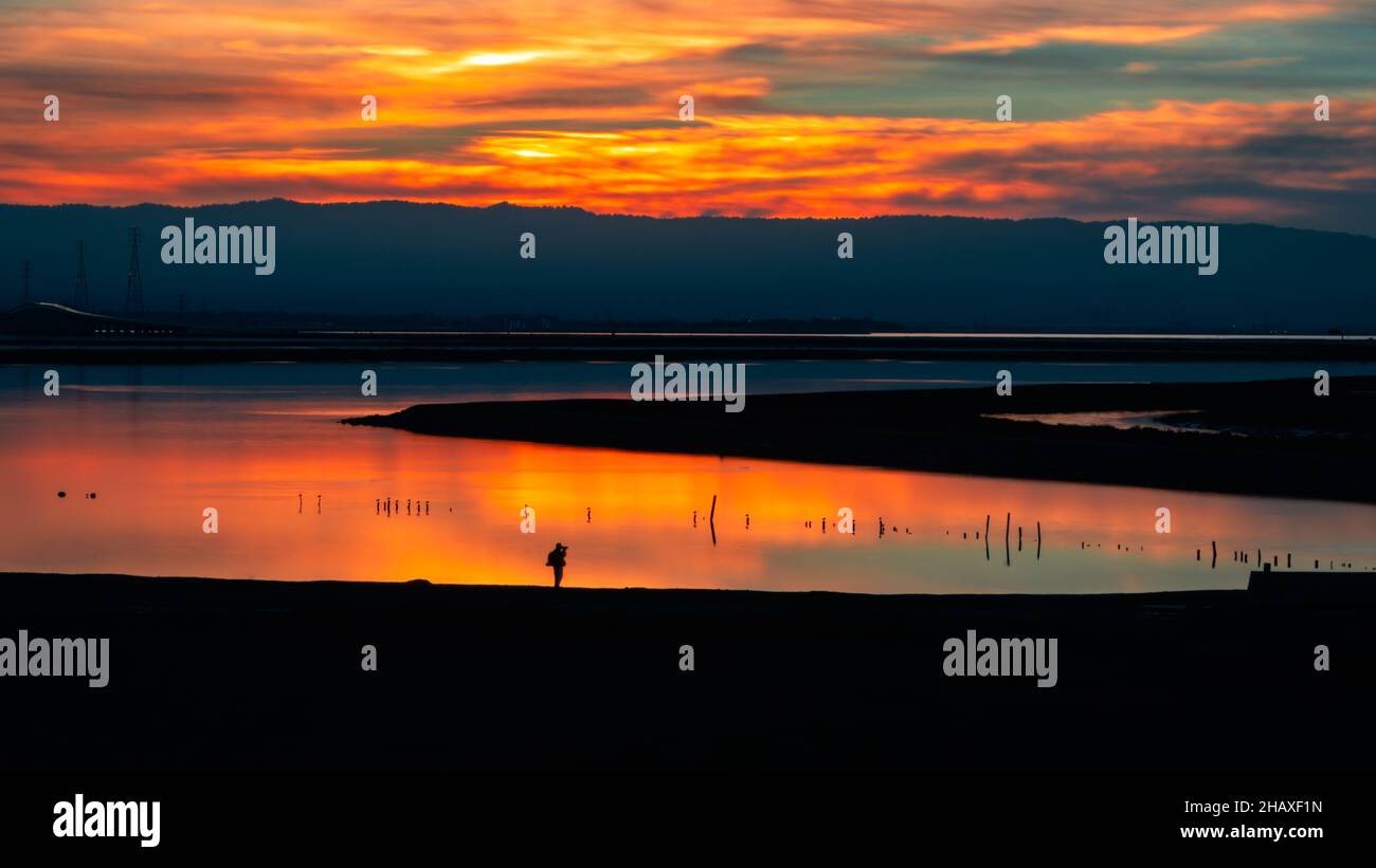 Beautiful orange sunset sky and its reflection on the lake Stock Photo ...