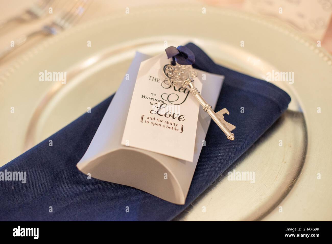 'the key to happiness is love and the ability to open a bottle ' guest gift with skeleton key and wedding reception Stock Photo