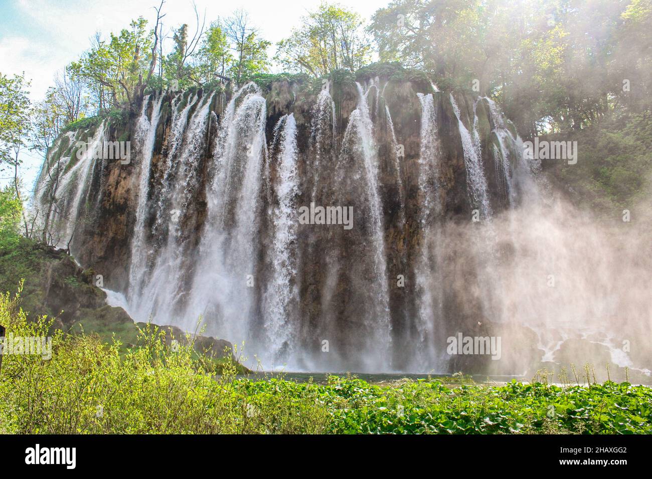Colorful spring panorama of green forest with blue lake. Great ...