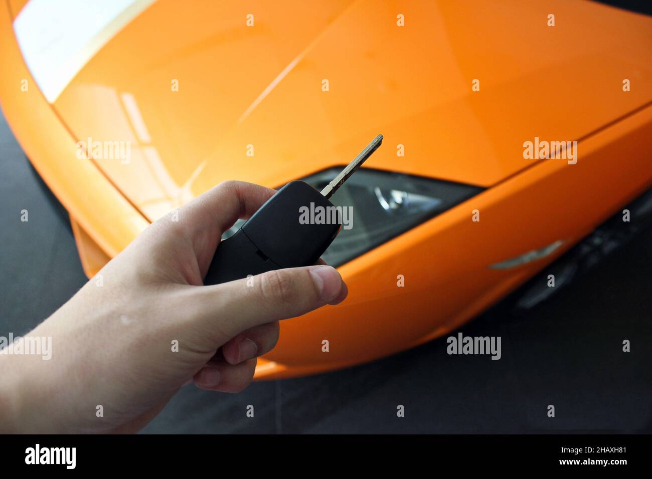 Keys in hand from a luxury car on the background of the car Stock Photo ...