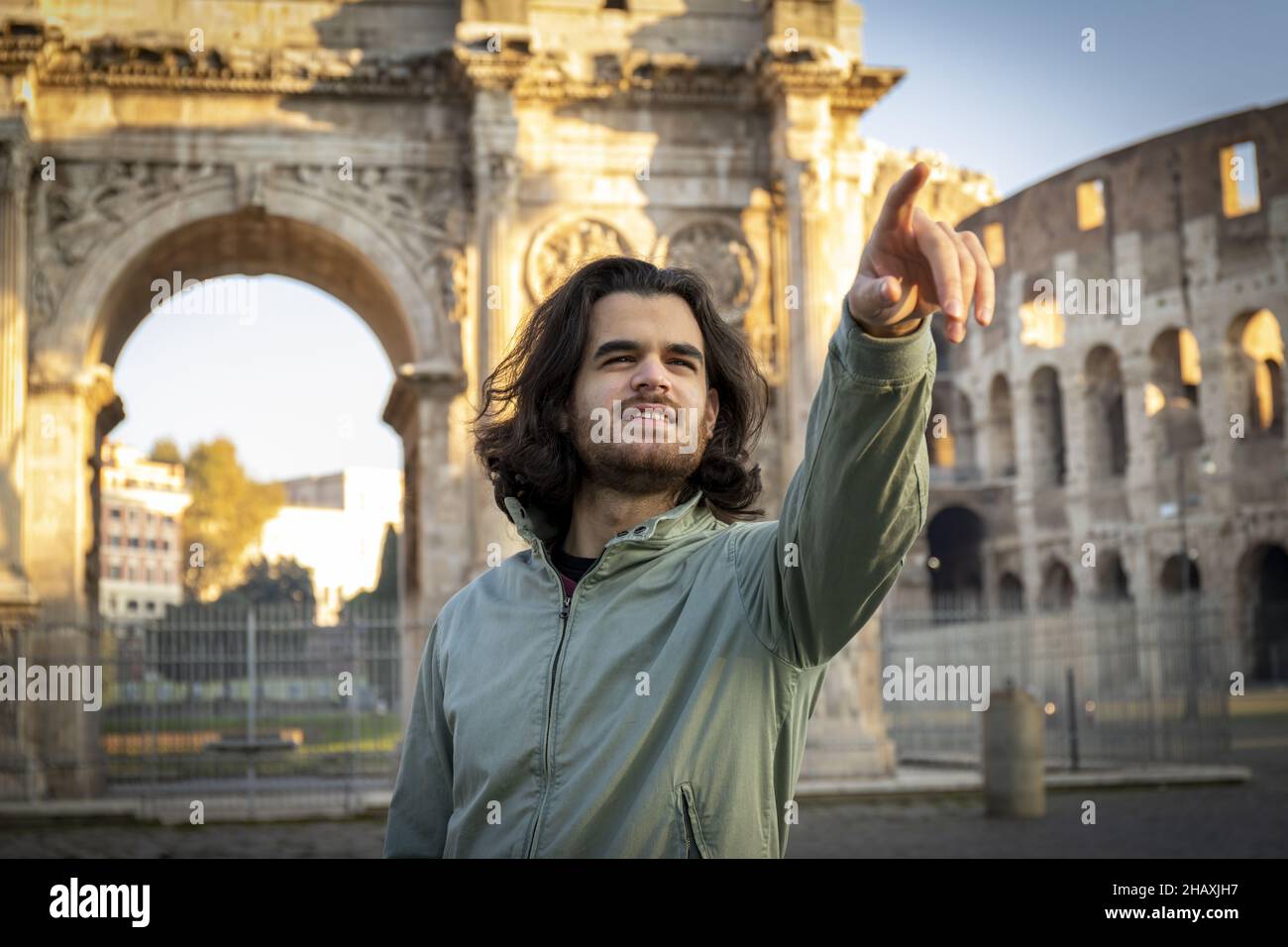 Happy moment on a trip to Rome. Young smiling man poses for a photo in ...