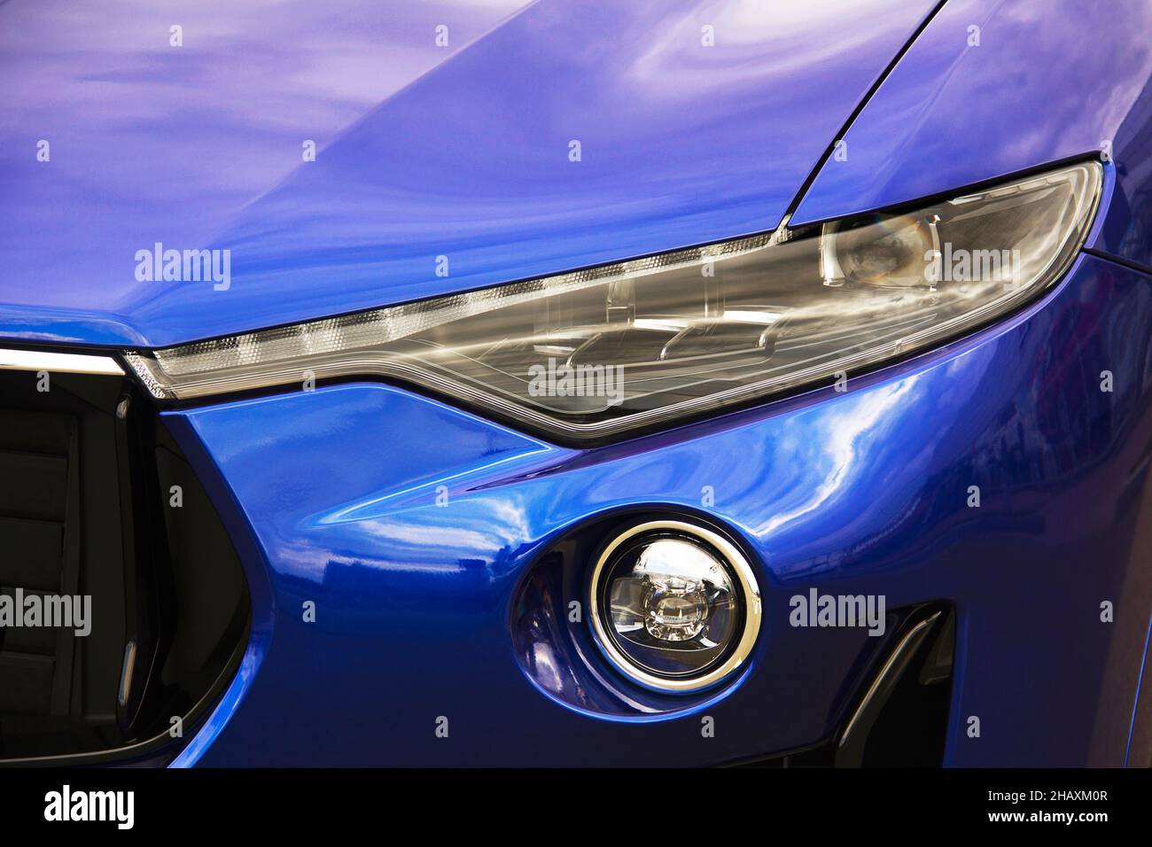 Car headlights. Luxury Headlights. Part of a blue car Stock Photo Alamy