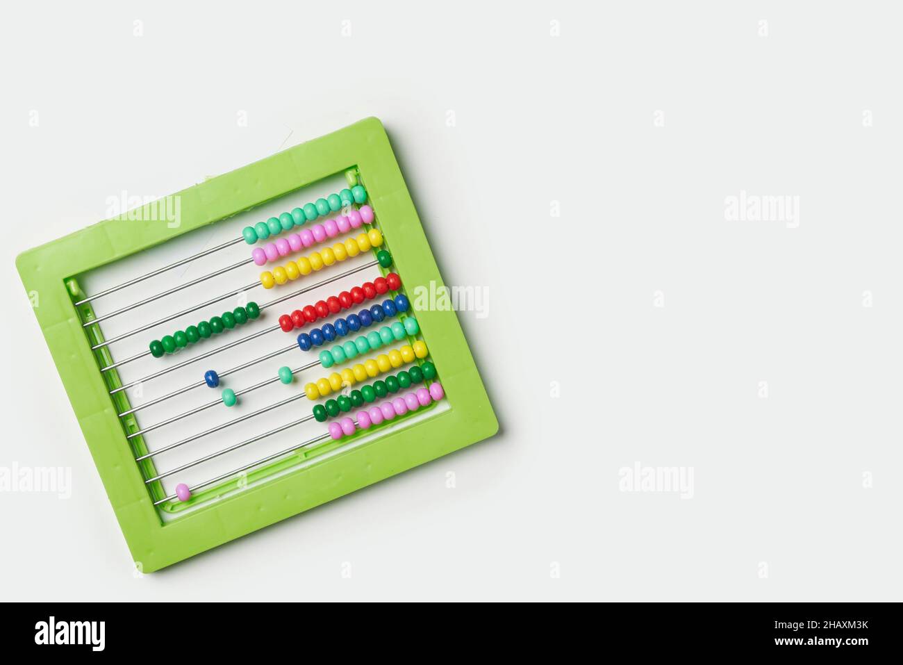 Colorful bead calculator on white. Green plastic manual bead counter