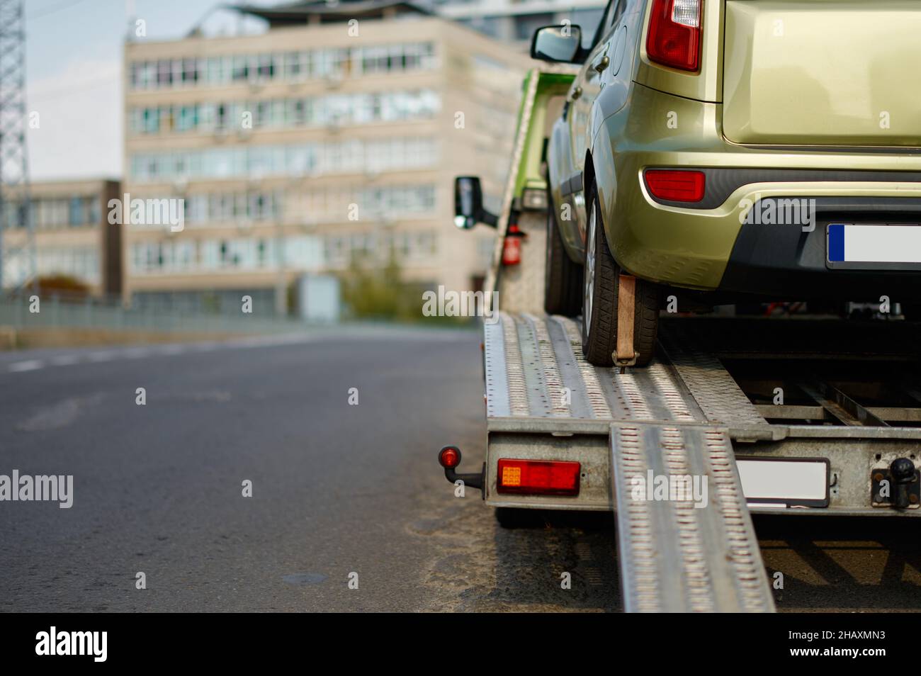 Broken car standing on flatbed tow truck Stock Photo