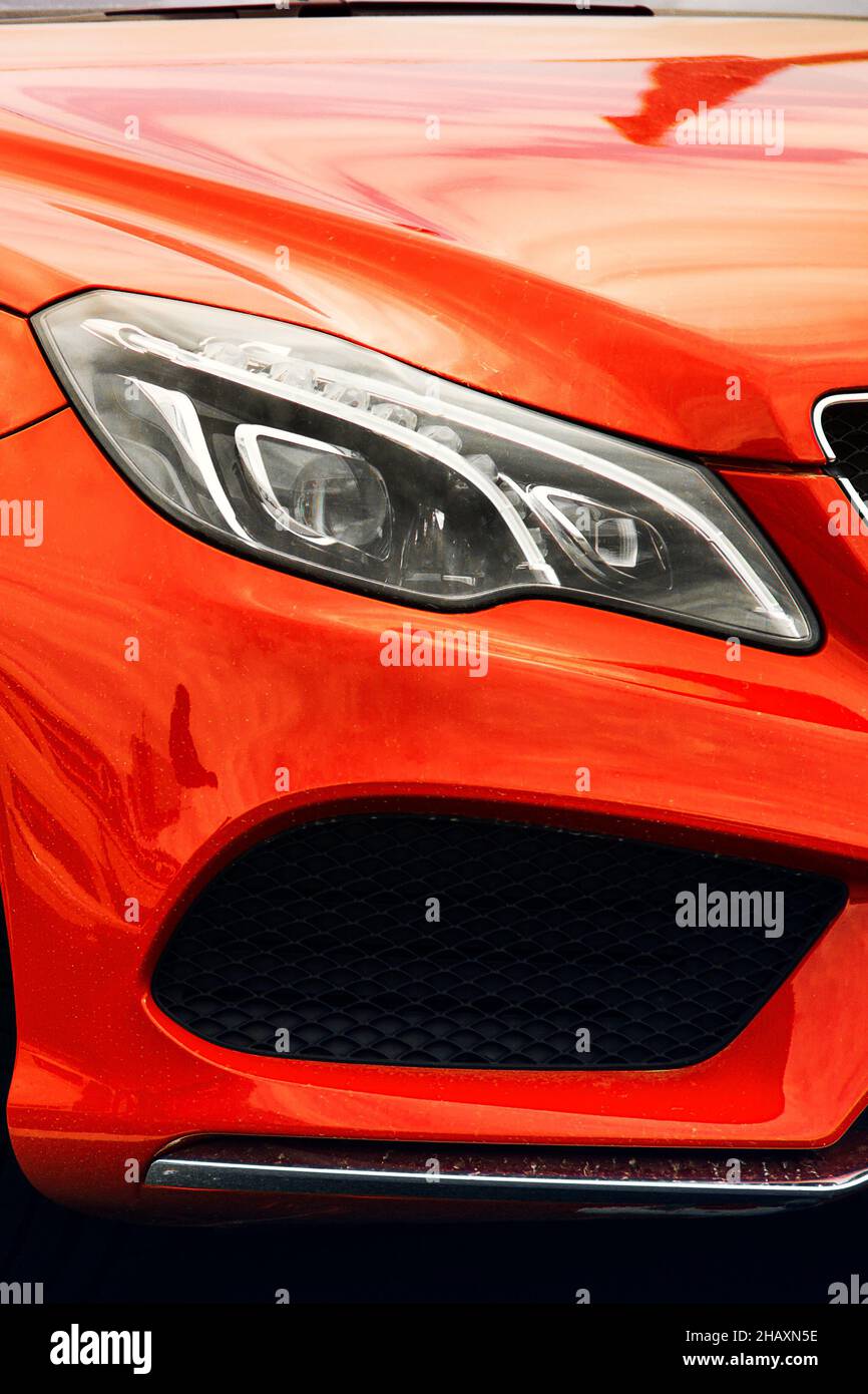 Car headlights. Luxury Headlights. Part of an orange car Stock Photo