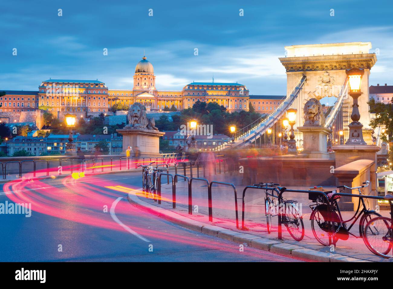 Chain bridge and Royal Palace in Budapest at night, traffic lights Stock Photo