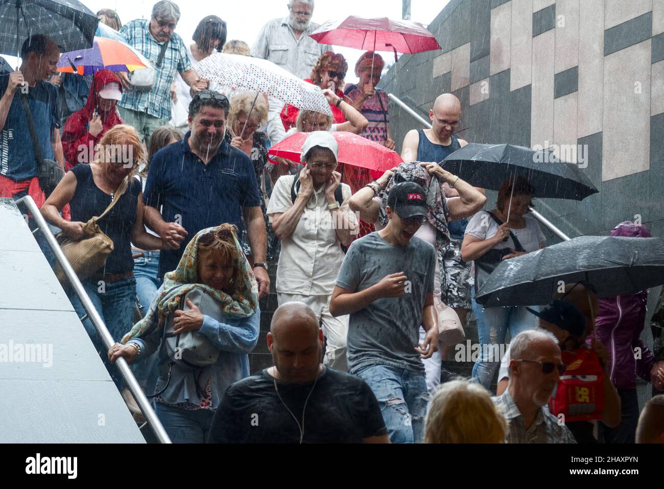 Crowd rushes to hide from the rain in the subway Stock Photo