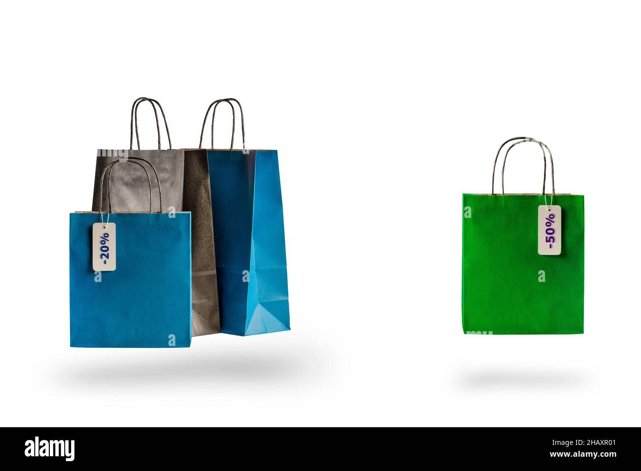 Set of multicolored shopping bags on a white isolated background. Sale and discounts 10, 20, 30, 40 ,50. Packages float in the air, casting a shadow Stock Photo