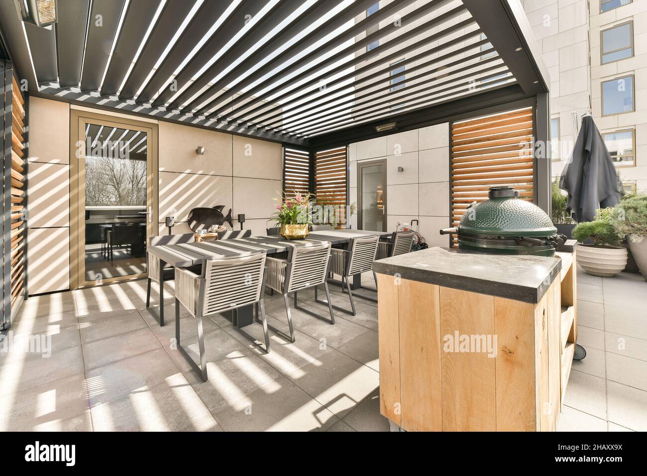 Exterior of spacious modern terrace with dining table with chairs