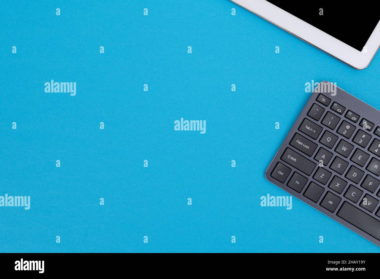 Office Workplace with Digital Gadgets Lying on Blue Table - Flat Lay Stock Photo