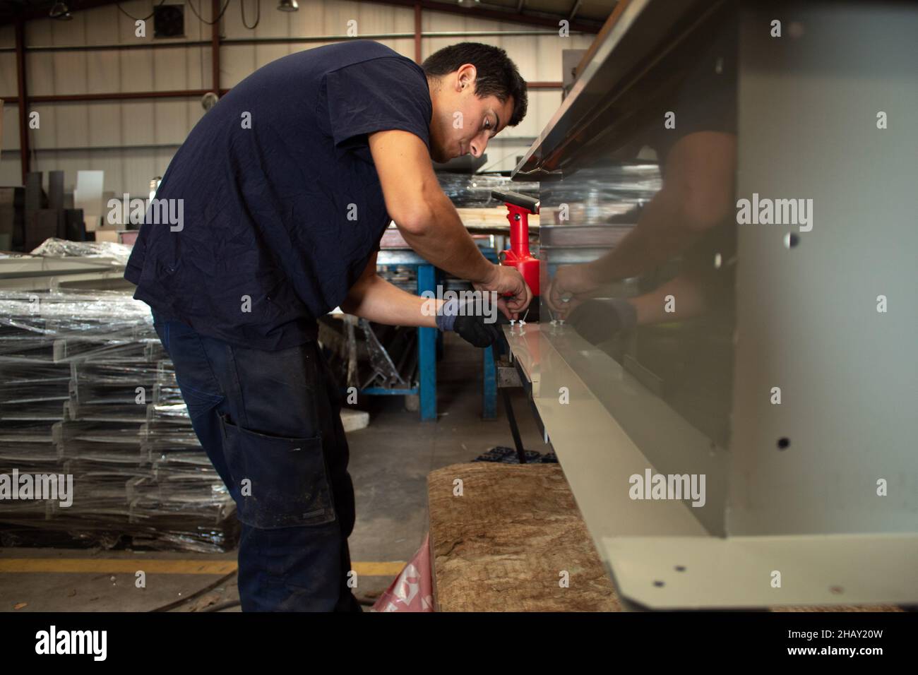 Craftsman rivet metal in the workshop Stock Photo - Alamy