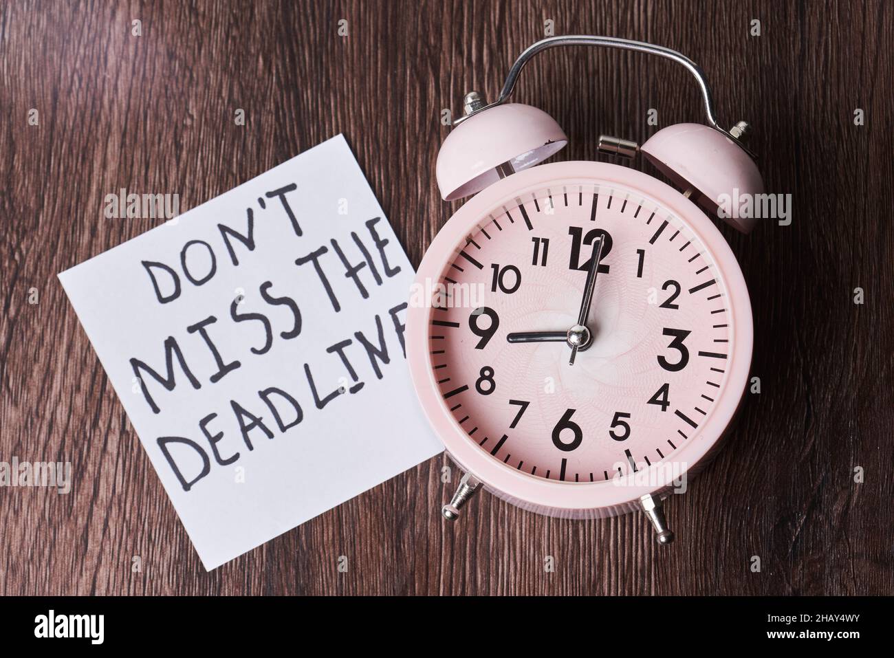 Dont miss the deadline. Deadline text on piece of paper, alarm clock ...