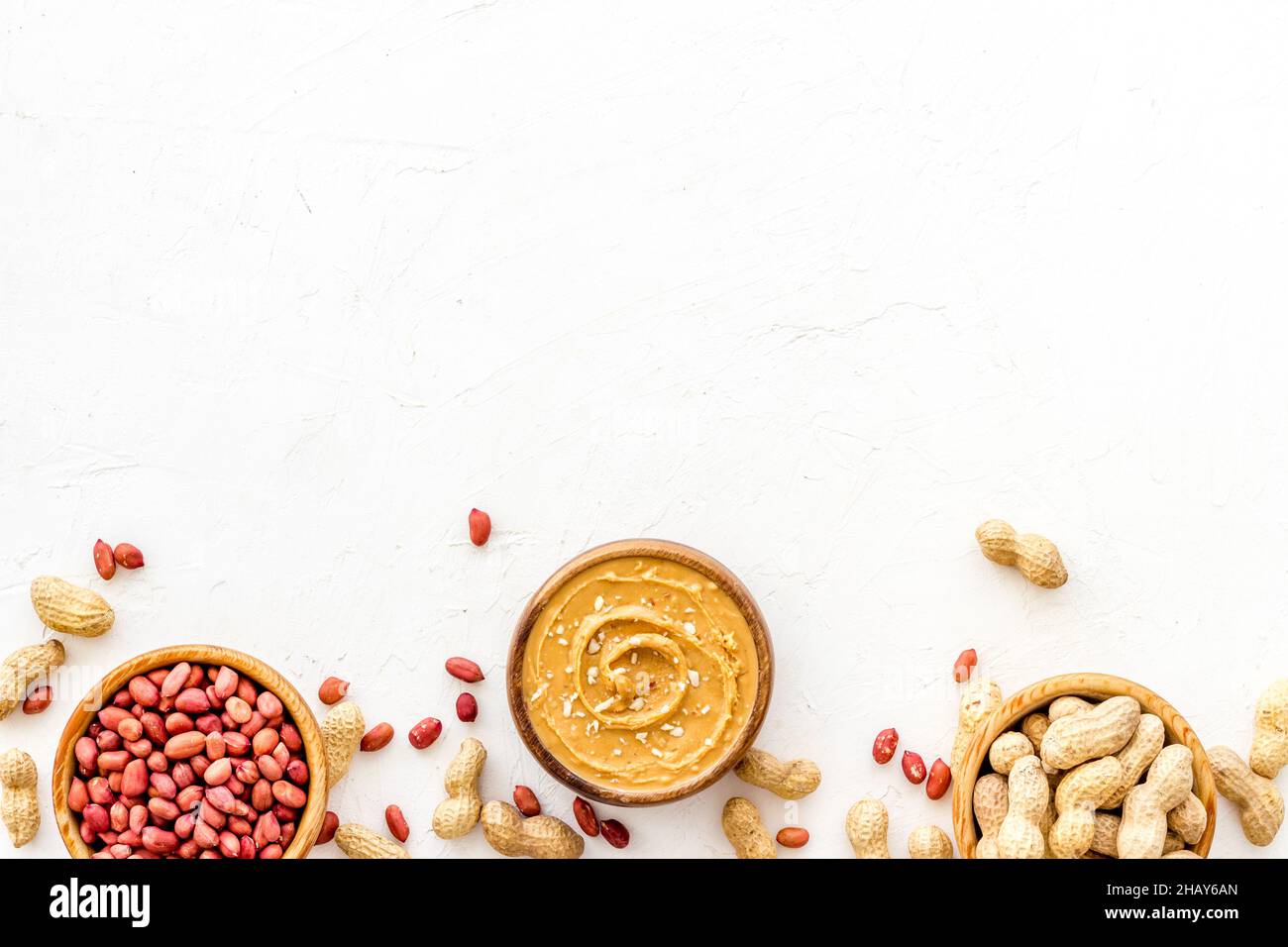 Creamy peanut butter and nuts in wooden bowls, top view Stock Photo Alamy