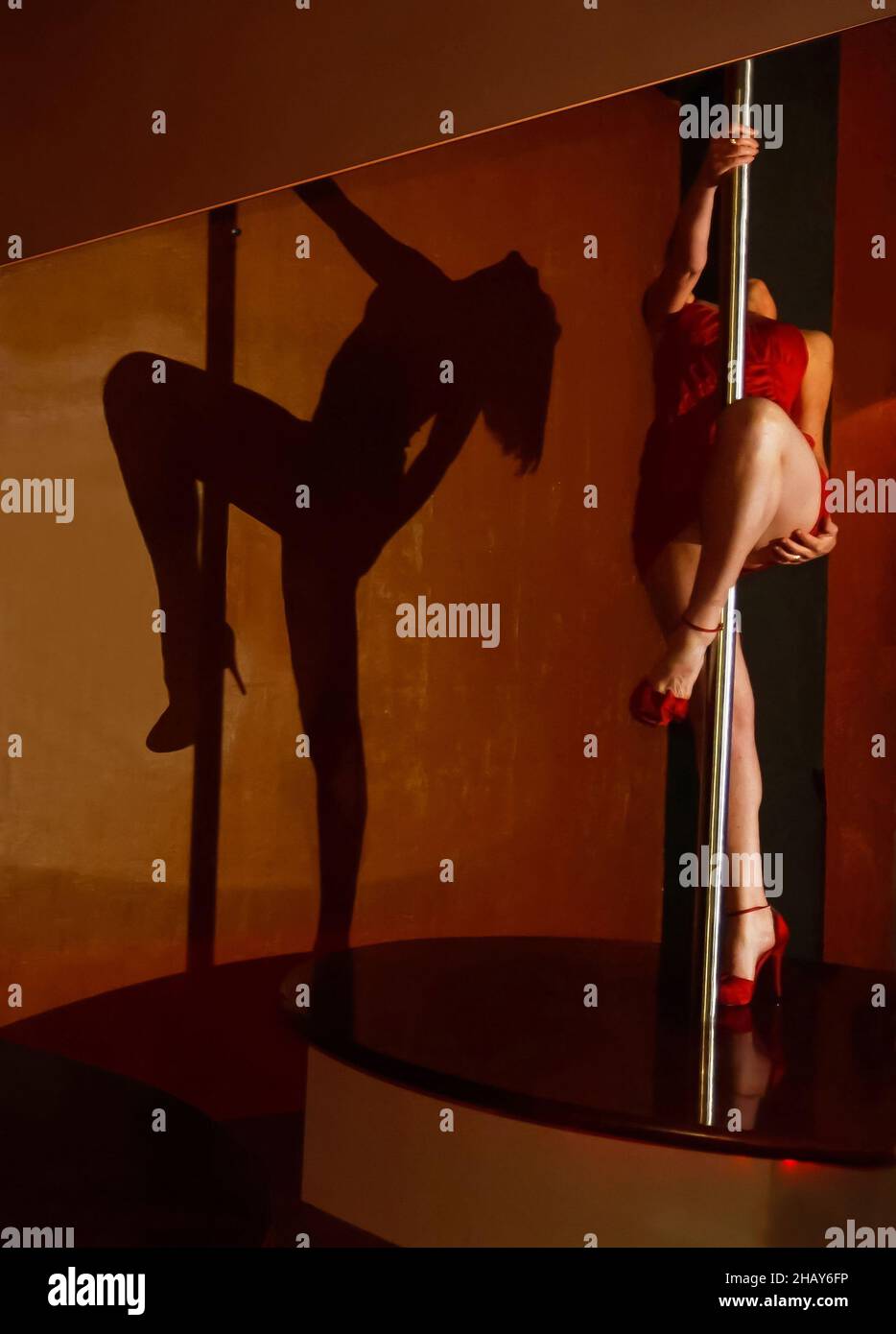 Slim young woman pole dancer on the pole Stock Photo