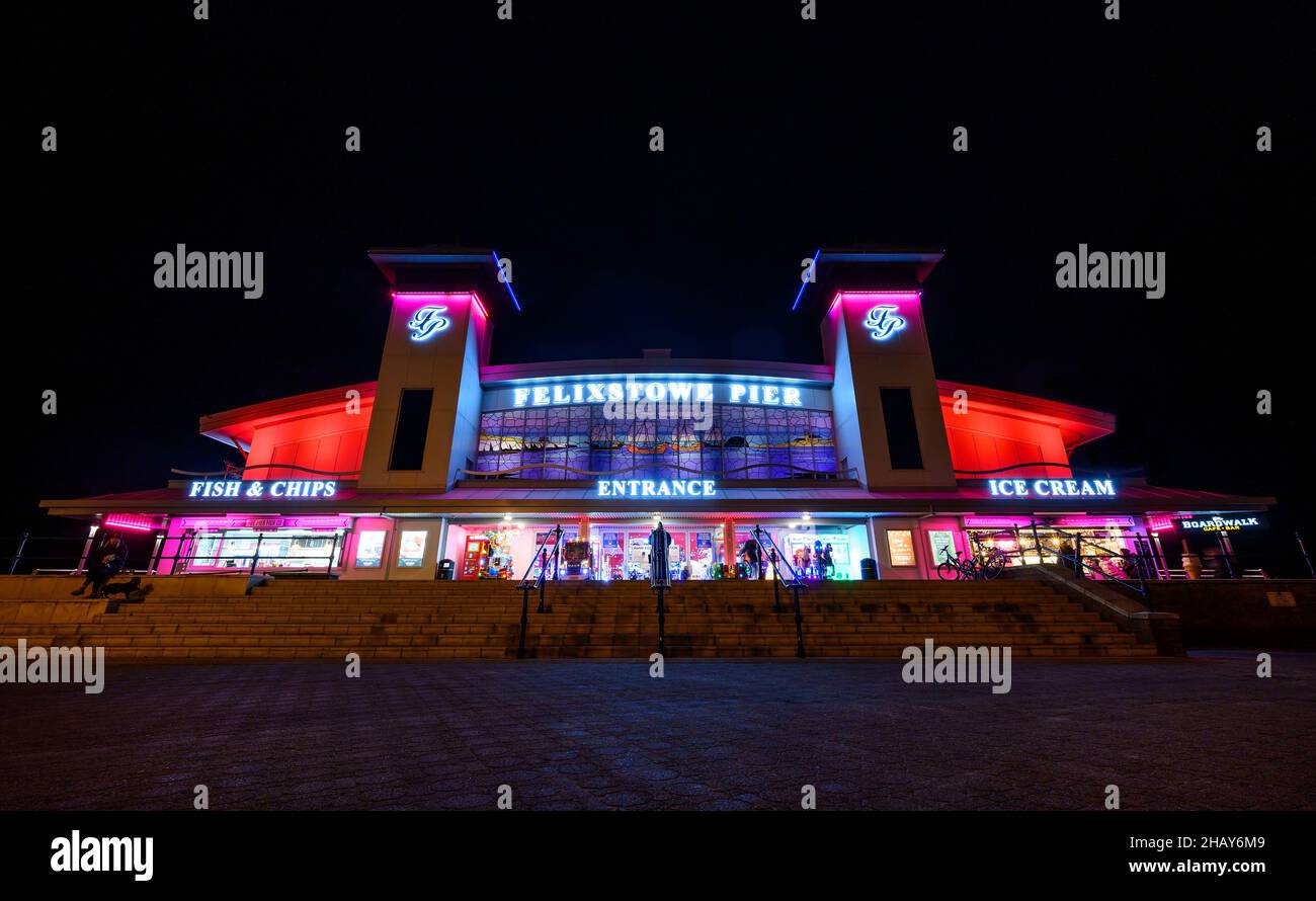 Felixstowe, Suffolk, UK: The entrance to Felixstowe pier at night illuminated with red lights. Stock Photo