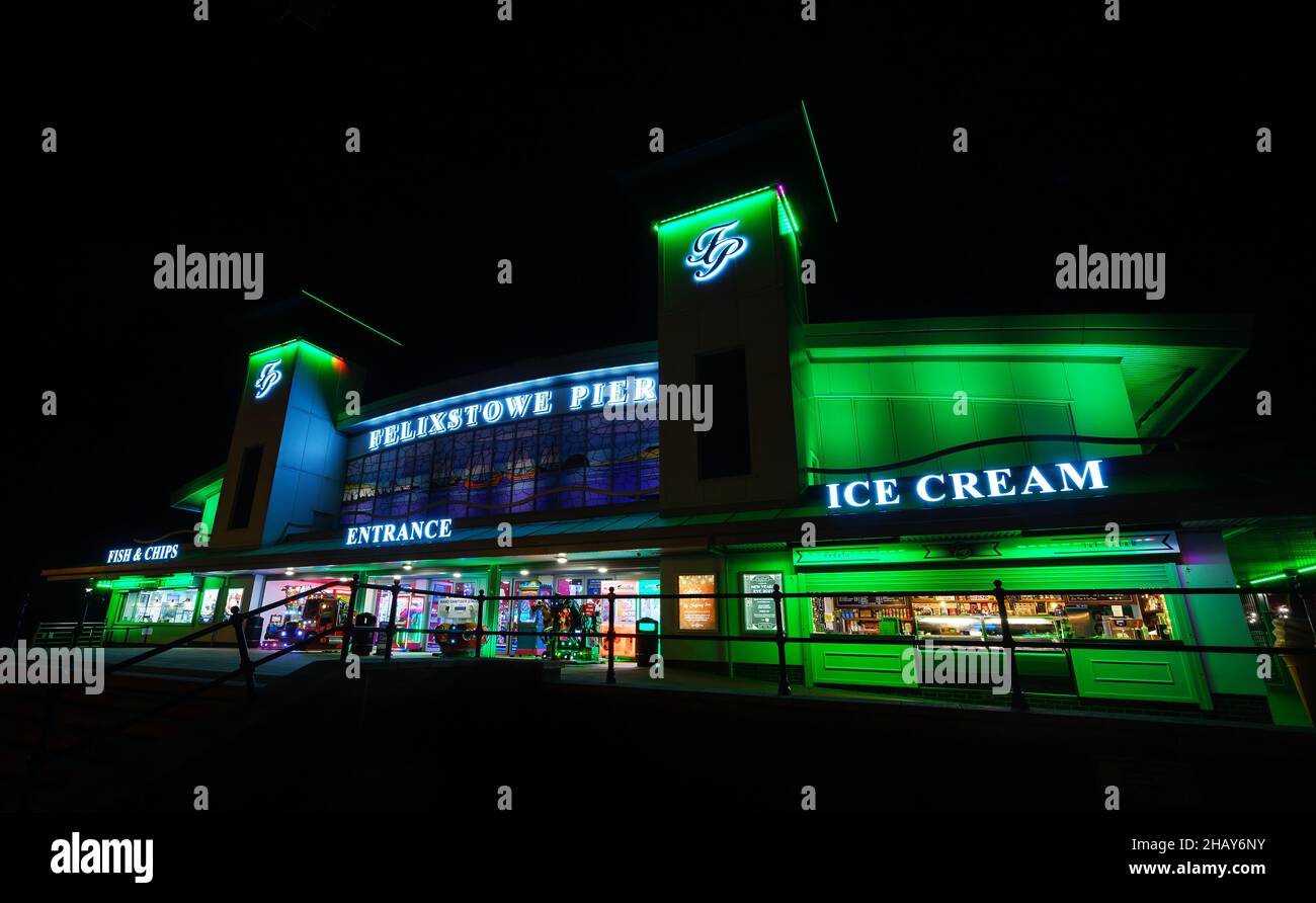 Felixstowe, Suffolk, UK: The entrance to Felixstowe pier at night illuminated with green lights. Stock Photo