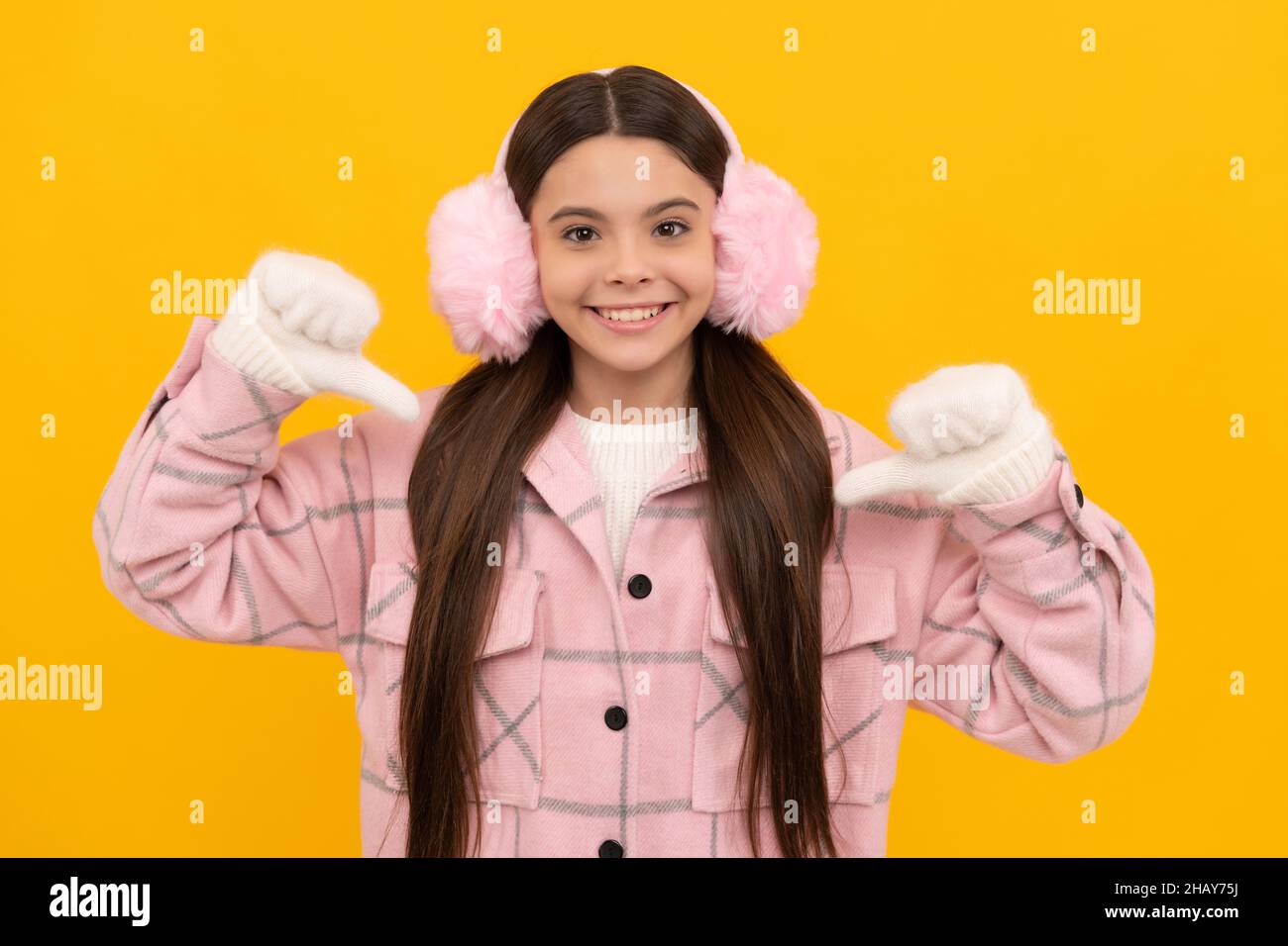portrait of child wearing warm clothes. express positive emotion. winter fashion. Stock Photo