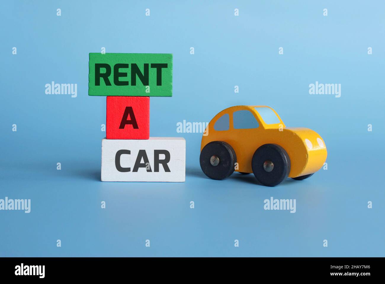 Business and finance concept. Wooden toy car and wooden cubes with text RENT A CAR Stock Photo