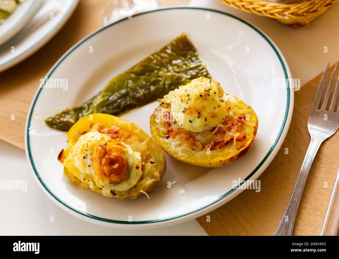 Potatoes stuffed with bacon, greens and eggs Stock Photo