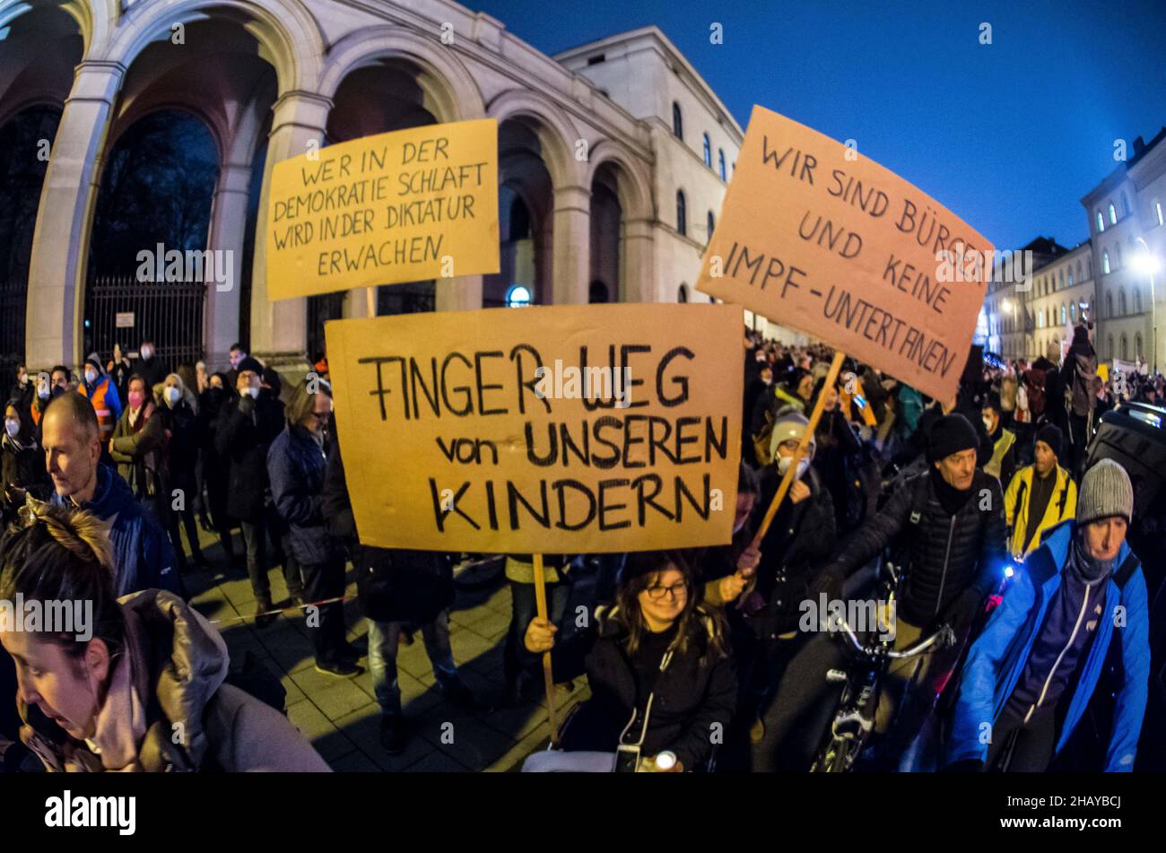 Munich, Bavaria, Germany. 15th Dec, 2021. Up to 3,500 Corona rebels, anti-vaxxers, conspiracy theorists, Reichsbuerger, neonazis, and Corona deniers assembled on Munich's Ludwigstrasse for a demonstration against a non-existent compulsory vaccination law, vaccines in general, masks and the pandemic control laws in place. Masking was extremely variable, while a large number of the masked were wearing them improperly. Distancing was nearly non-existent and there appeared to be few to no controls in place. Passersby remarked sarcastically about how the people inside 'must all have docto Stock Photo