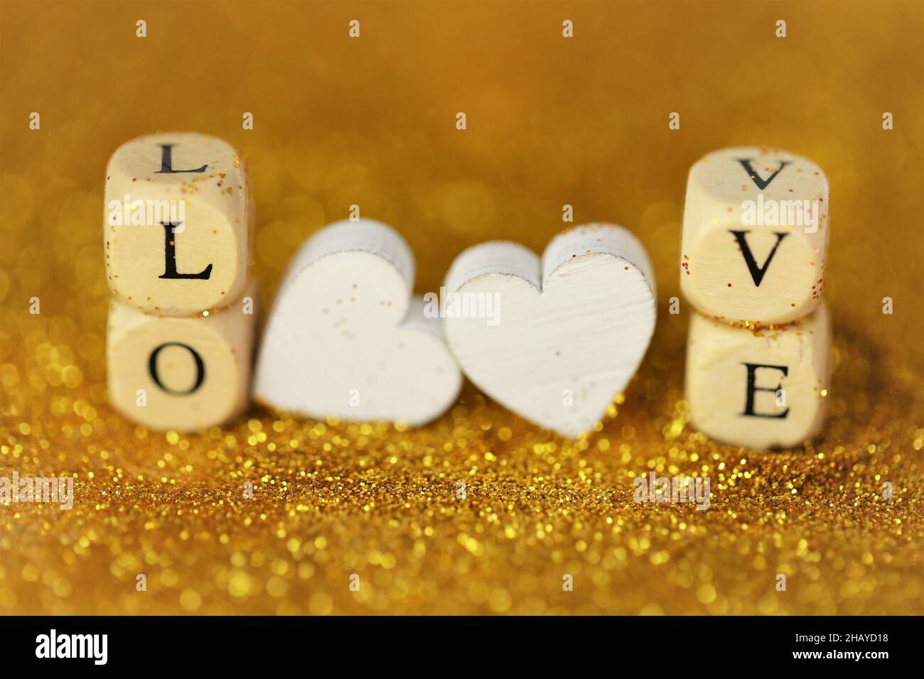 Love and 's Day. Inscription love made of wooden  letters and hearts on a gold glitter background with gold bokeh. Valentines  day Stock Photo - Alamy