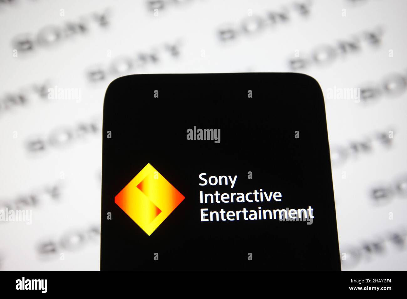 Ukraine. 15th Dec, 2021. In this photo illustration, Sony Interactive Entertainment (SIE) logo seen displayed on a smartphone with Sony logos in the background. (Photo by Pavlo Gonchar/SOPA Images/Sipa USA) Credit: Sipa USA/Alamy Live News Stock Photo
