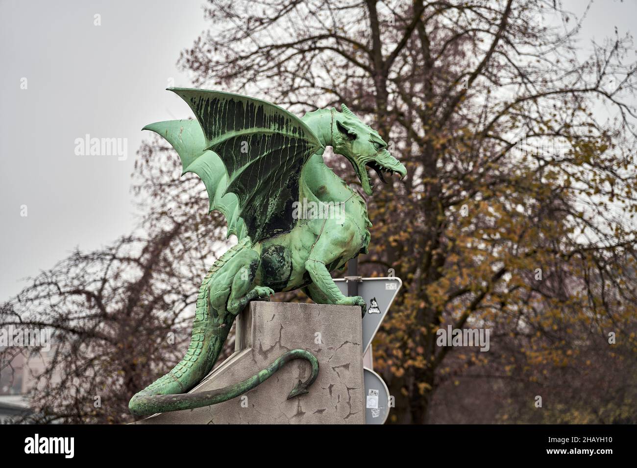 Selective focus shot of a green dragon sculpture with its mouth open in ...